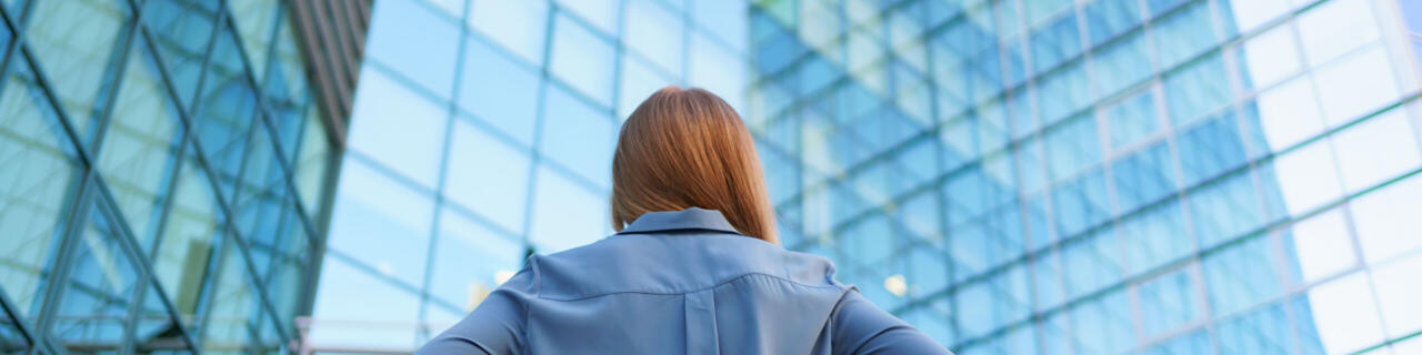 Back view successful manager looking business building modern city